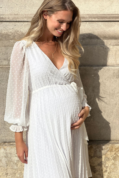 Maternity wedding dress in a wrap style with a pleated skirt