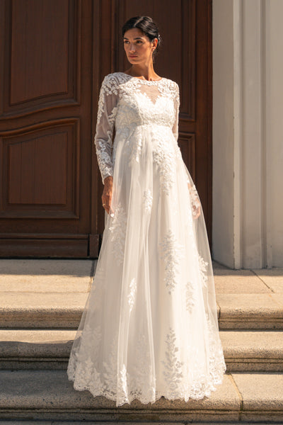 Maternity bridal gown with sweetheart neckline and lace appliqués